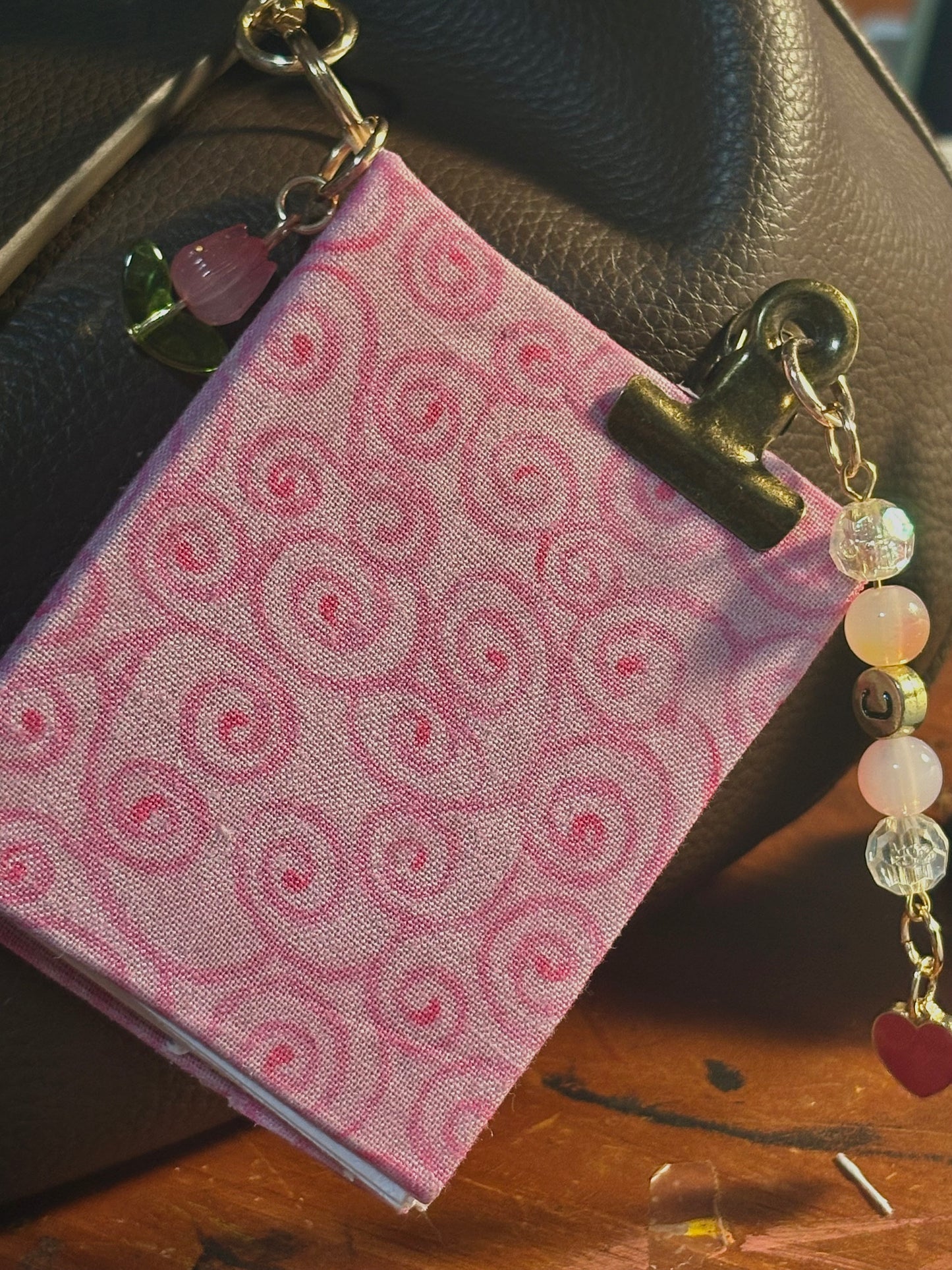 handmade fabric-bound mini journal with removable keychain charm and beaded binder clip journal charm, pink floral cover