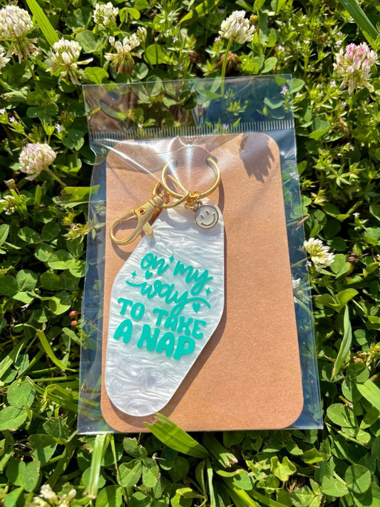 handmade motel style acrylic keychain pearlescent white tag teal lettering on my way to take a nap gold clasp smiley face charm
