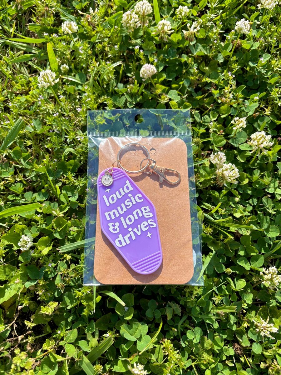 handmade motel style purple acrylic keychain white lettering loud music and long drives gold clasp smiley charm