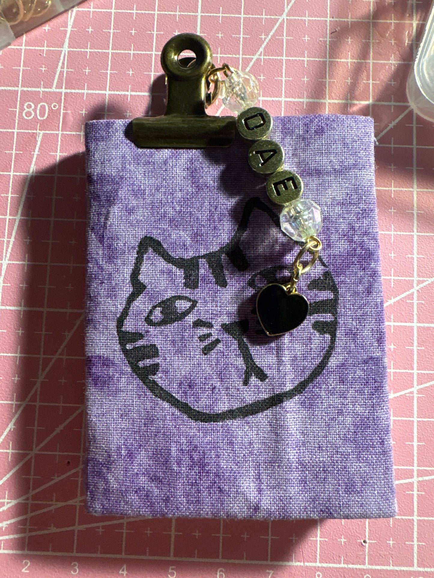 closed 3x2 inch mini journal with pink floral fabric cover and beaded initial charm, handmade cottagecore stationery