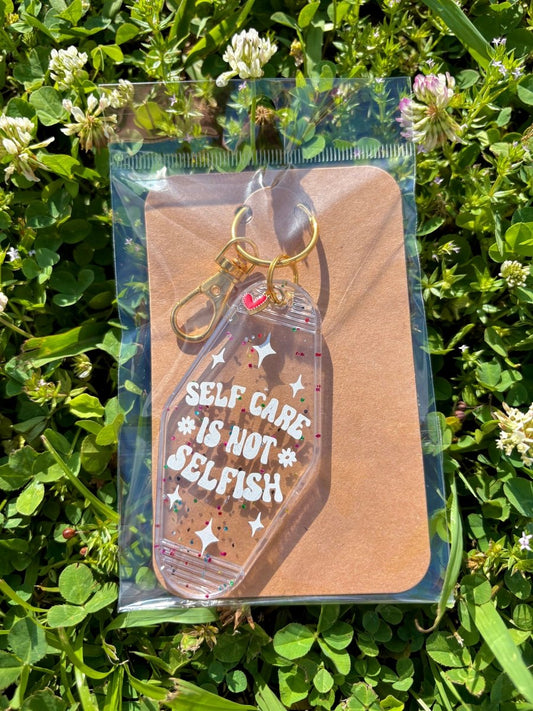 handmade motel style clear confetti glitter acrylic keychain white lettering self care is not selfish daisy details gold clasp heart charm